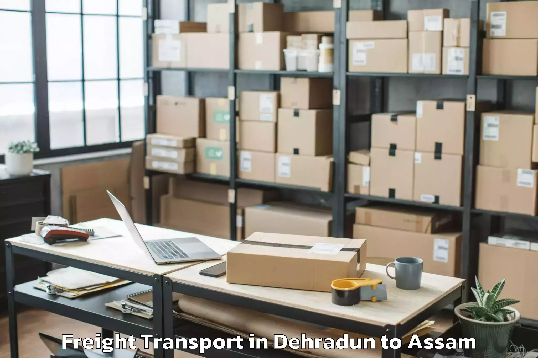 Book Dehradun to Behali Freight Transport